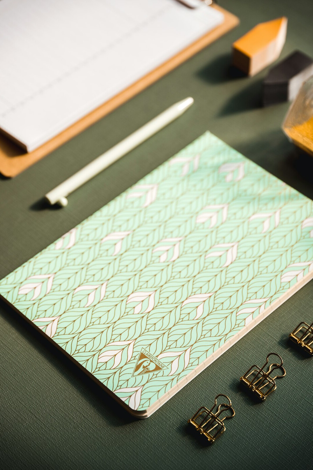 Overhead flatlay of open notebook, pen and documents on a desk